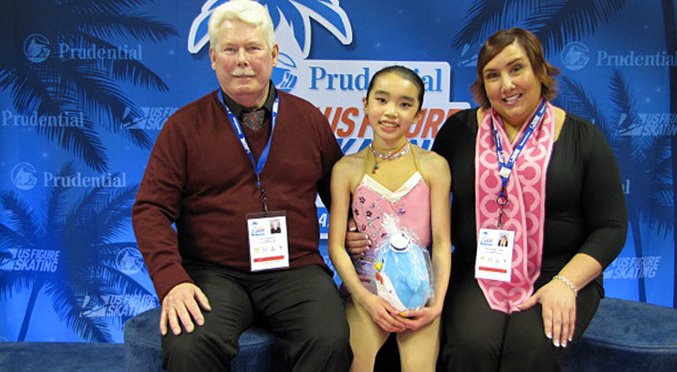 Karen Chen and her coaches in kiss and cry area after short program